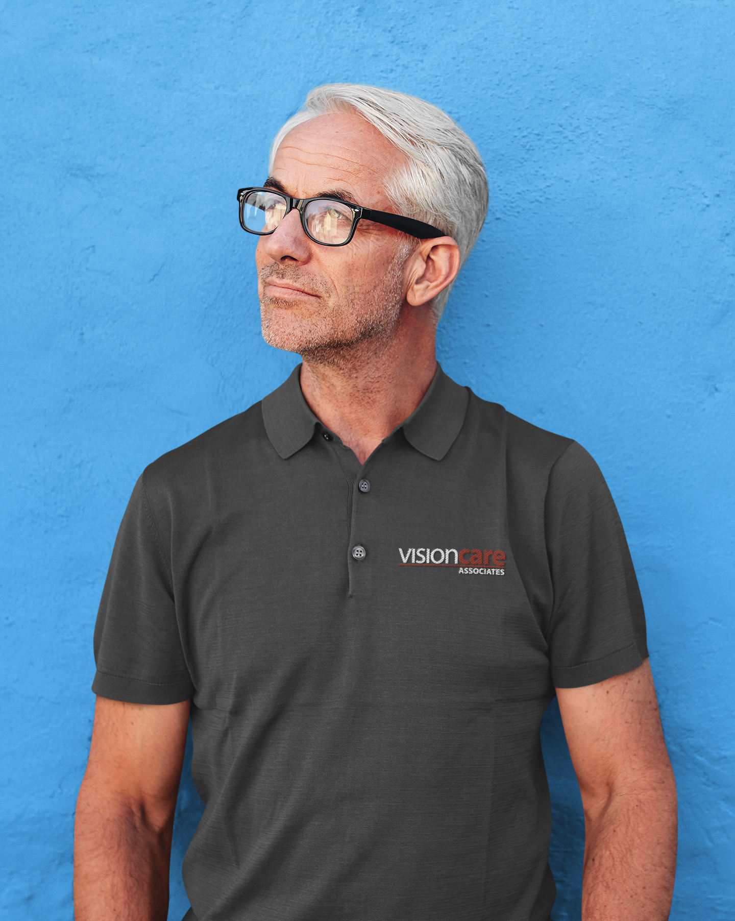 Person wearing black polo and left chest VisionCare Associates Logo.